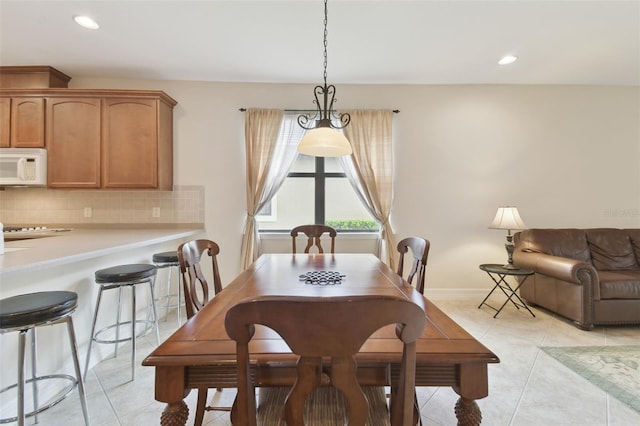 dining room featuring light tile patterned floors, baseboards, and recessed lighting