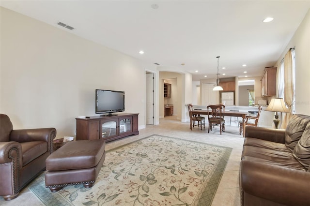 living room with recessed lighting, visible vents, baseboards, and light tile patterned floors