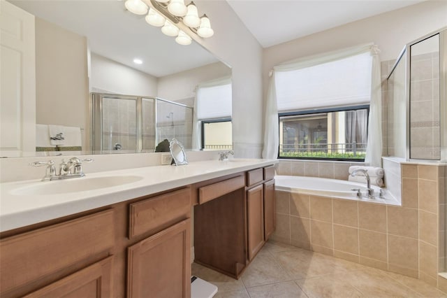 bathroom featuring a garden tub, tile patterned flooring, a sink, double vanity, and a stall shower