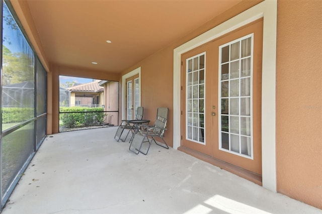 unfurnished sunroom featuring french doors