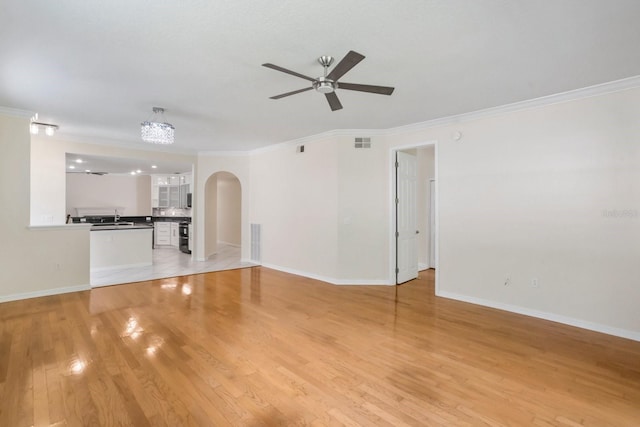 unfurnished living room with crown molding, sink, ceiling fan with notable chandelier, and light hardwood / wood-style floors