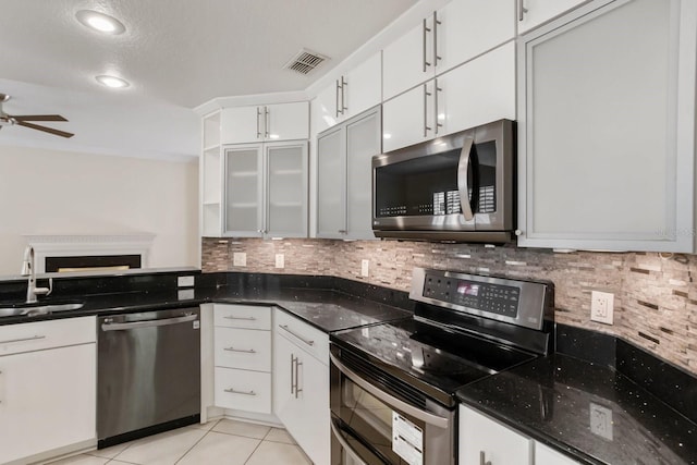 kitchen featuring tasteful backsplash, appliances with stainless steel finishes, sink, and white cabinets