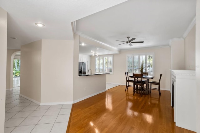 dining area with light tile patterned floors, crown molding, a wealth of natural light, and ceiling fan