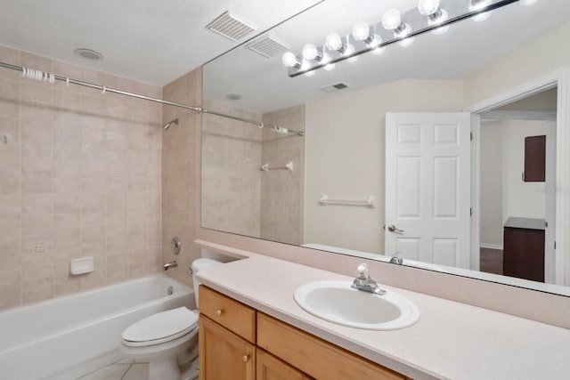 full bathroom featuring tiled shower / bath, vanity, and toilet