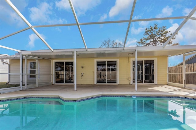 back of house with a patio and glass enclosure