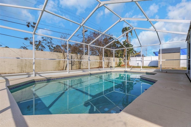 view of pool with a patio and glass enclosure