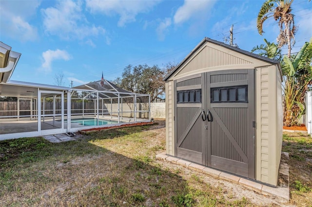 view of outdoor structure featuring a yard and a fenced in pool