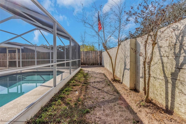 view of pool with glass enclosure