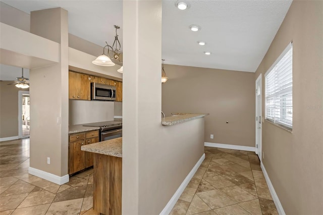 kitchen featuring hanging light fixtures, stainless steel appliances, kitchen peninsula, and ceiling fan