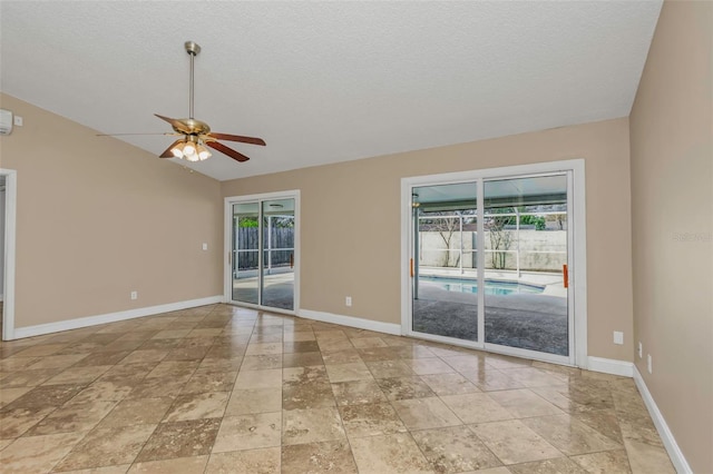 spare room featuring ceiling fan, vaulted ceiling, and a textured ceiling