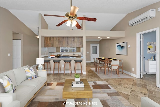 living room with vaulted ceiling, an AC wall unit, sink, ceiling fan, and a textured ceiling