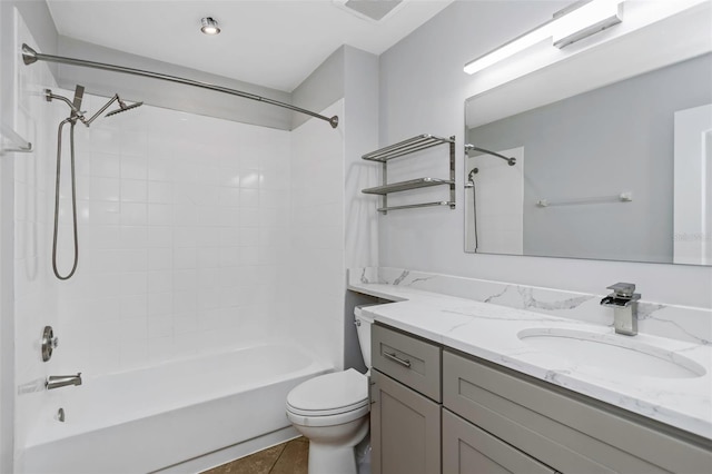 full bathroom featuring tiled shower / bath, vanity, and toilet