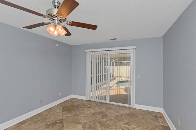 spare room featuring ceiling fan and a textured ceiling