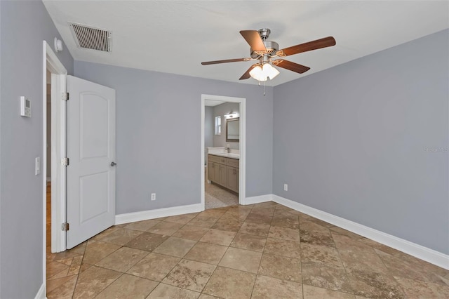 unfurnished bedroom with sink, connected bathroom, ceiling fan, and light tile patterned floors