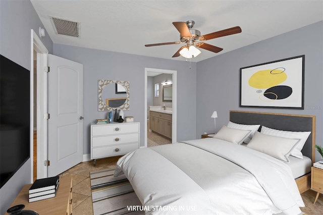 bedroom with sink, connected bathroom, and ceiling fan