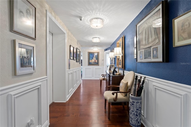 corridor featuring dark wood-type flooring and a textured ceiling