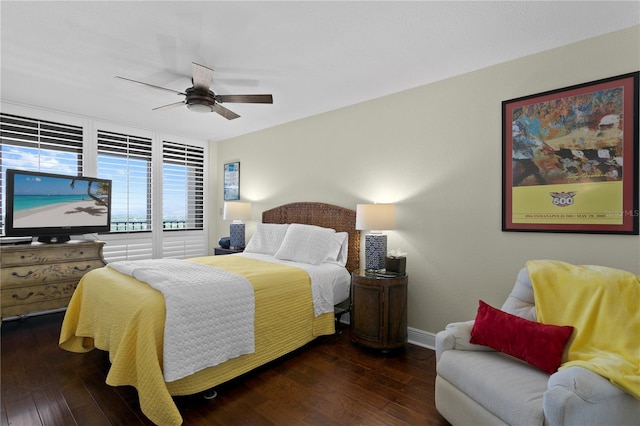 bedroom with ceiling fan and dark hardwood / wood-style flooring