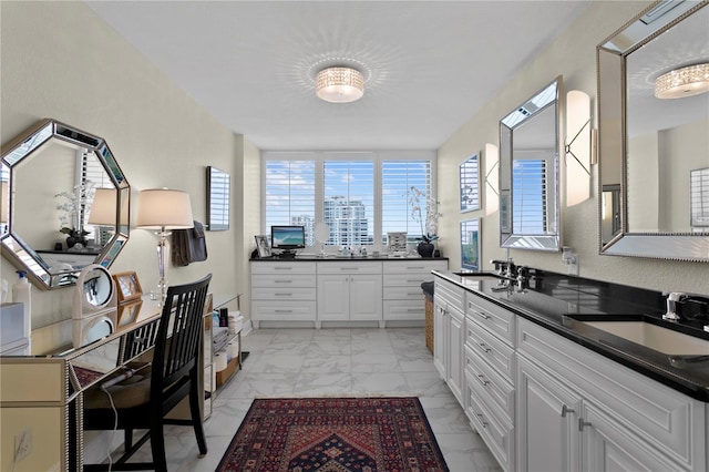 kitchen featuring sink and white cabinets