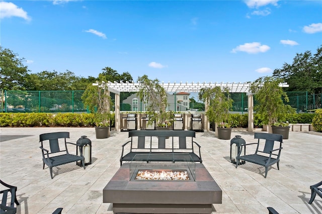 view of patio / terrace featuring a pergola and a fire pit