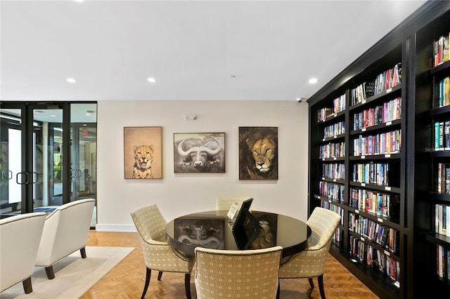 dining space featuring parquet flooring