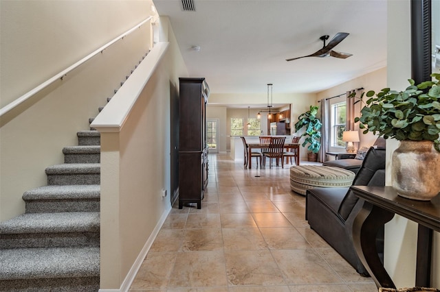 interior space with ceiling fan