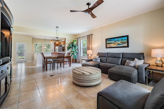 living room featuring light tile patterned floors and ceiling fan