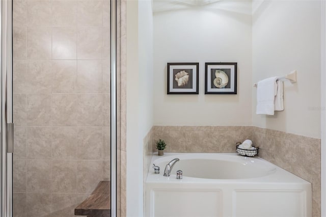 bathroom featuring shower with separate bathtub