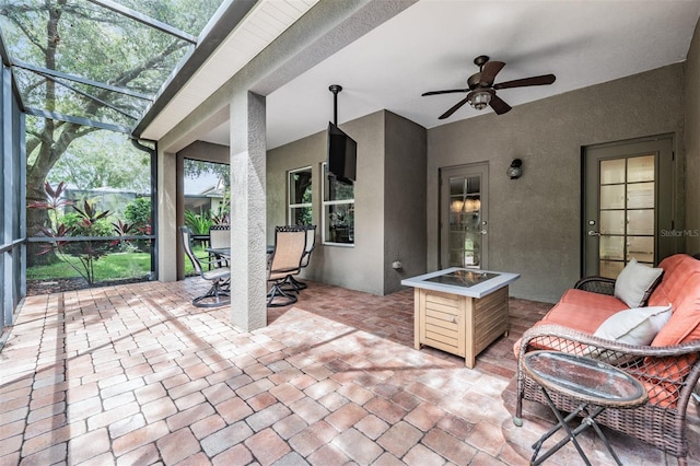 view of patio / terrace with a lanai and ceiling fan