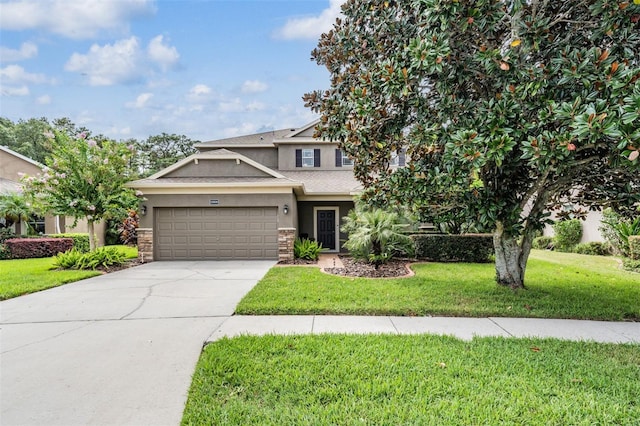 view of front of property with a garage and a front lawn