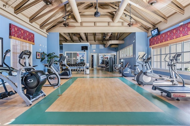 workout area with wooden ceiling and high vaulted ceiling