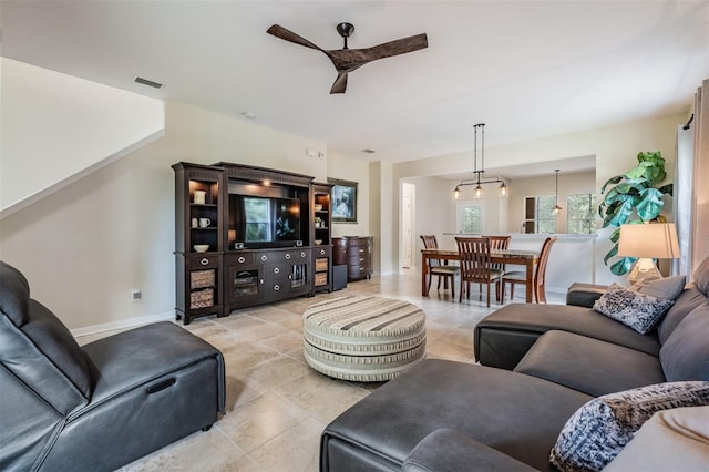 19308 Sunset Bay Dr, Land O Lakes, FL 34638 - living room featuring a ceiling fan, light tile patterned floors, and baseboards