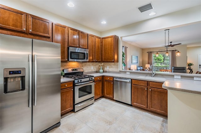 19308 Sunset Bay Dr, Land O Lakes, FL 34638 - kitchen featuring appliances with stainless steel finishes, a sink, light countertops, backsplash, and recessed lighting