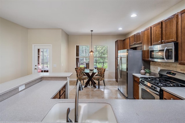 19308 Sunset Bay Dr, Land O Lakes, FL 34638 - kitchen with appliances with stainless steel finishes, pendant lighting, light countertops, recessed lighting, and a sink