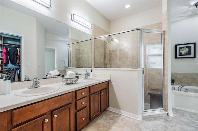 19308 Sunset Bay Dr, Land O Lakes, FL 34638 - full bath featuring a stall shower, double vanity, a bath, a spacious closet, and tile patterned flooring