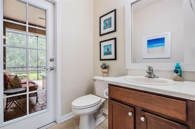 19308 Sunset Bay Dr, Land O Lakes, FL 34638 - half bathroom featuring toilet, vanity, tile patterned floors, and baseboards