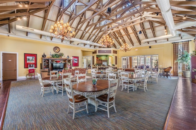 19308 Sunset Bay Dr, Land O Lakes, FL 34638 - dining space with a chandelier, high vaulted ceiling, wood finished floors, and baseboards