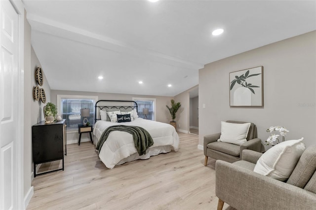 bedroom featuring lofted ceiling and light hardwood / wood-style flooring