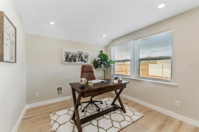 office space featuring vaulted ceiling and light wood-type flooring