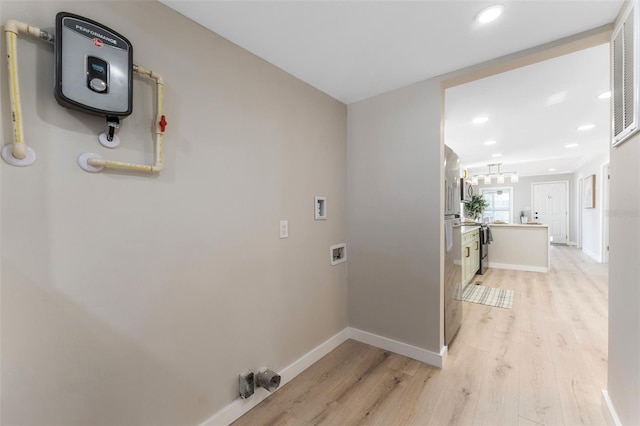 washroom with washer hookup and light hardwood / wood-style floors