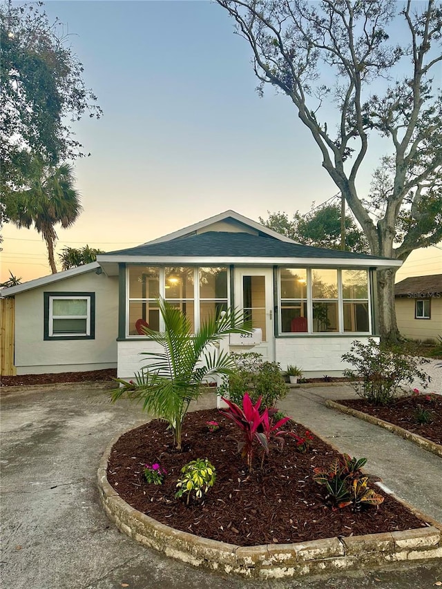 view of front of property featuring a sunroom