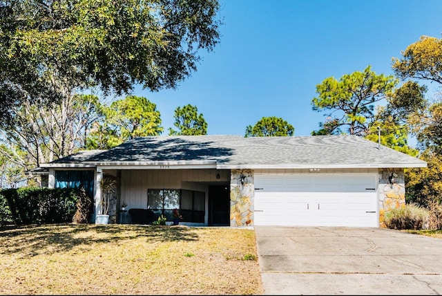 single story home featuring a garage and a front yard