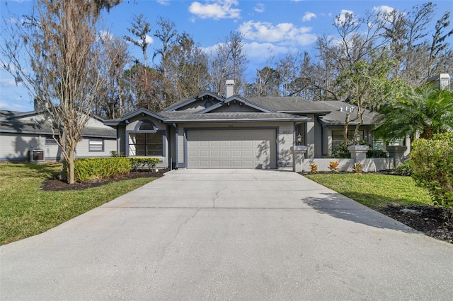 ranch-style home featuring a garage and a front lawn