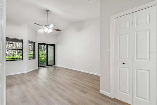 unfurnished room featuring ceiling fan, lofted ceiling, and light hardwood / wood-style floors