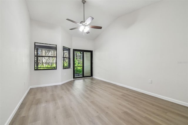 unfurnished room featuring light hardwood / wood-style flooring, high vaulted ceiling, and ceiling fan