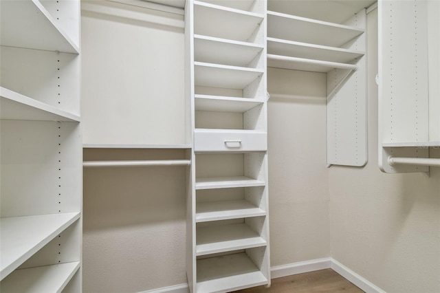 spacious closet featuring hardwood / wood-style flooring