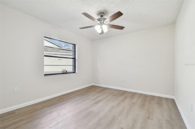 spare room with ceiling fan, a textured ceiling, and light hardwood / wood-style floors