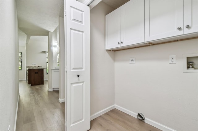 laundry room featuring cabinets, washer hookup, light hardwood / wood-style flooring, and electric dryer hookup