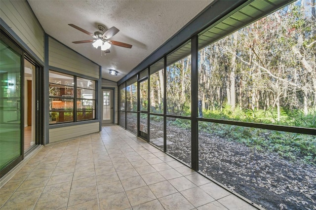 unfurnished sunroom with lofted ceiling and ceiling fan