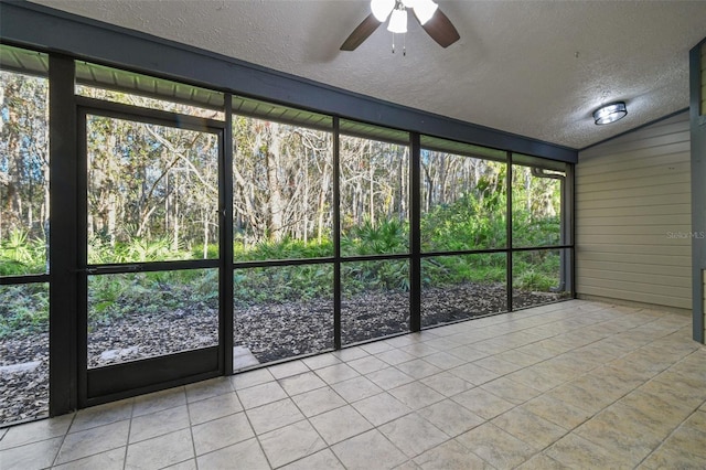 unfurnished sunroom featuring ceiling fan and vaulted ceiling