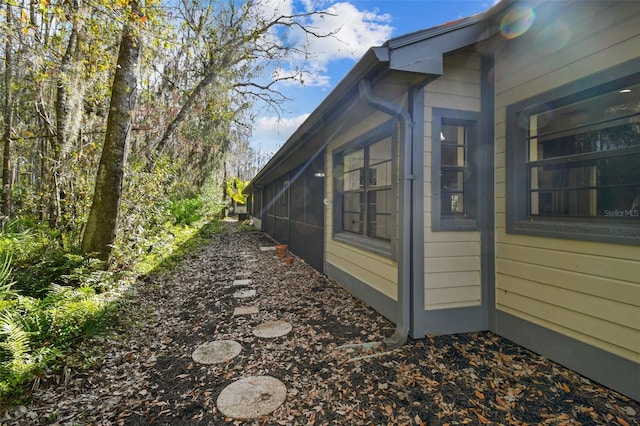 view of home's exterior with a sunroom